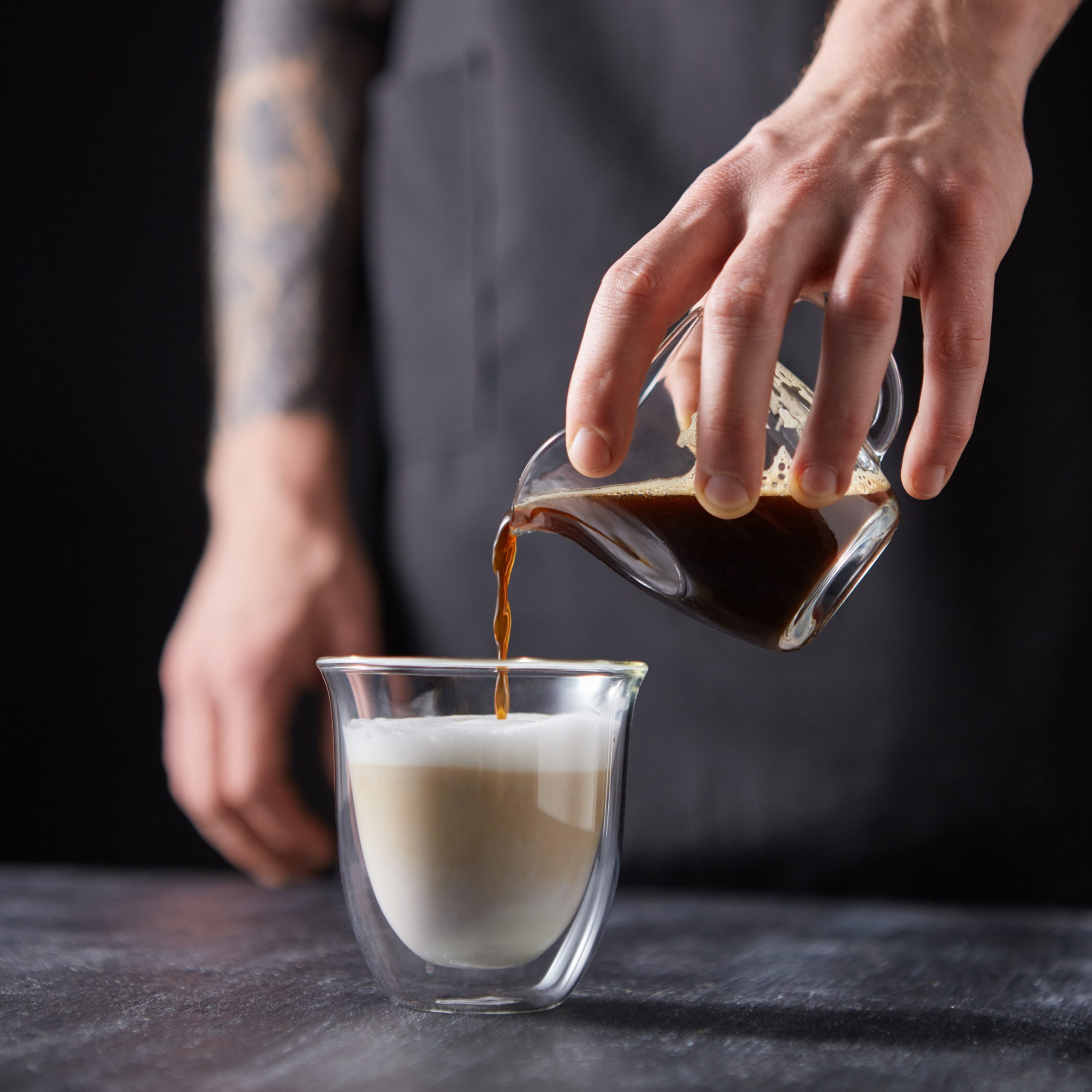 a-man-39-s-hand-pours-coffee-into-a-cup-of-milk-o-2024-09-13-23-02-24-utc-scaled